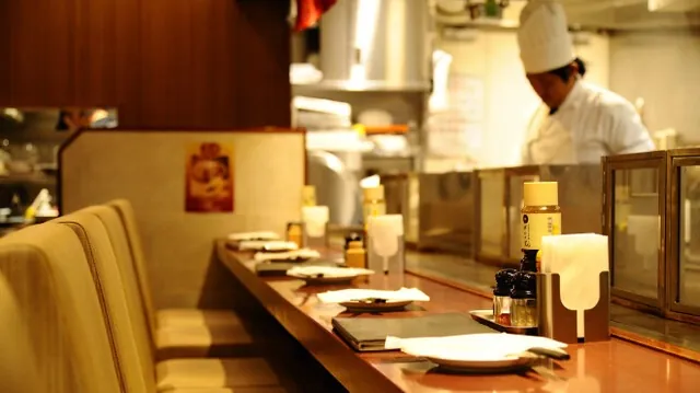鉄板の前に立つ料理人